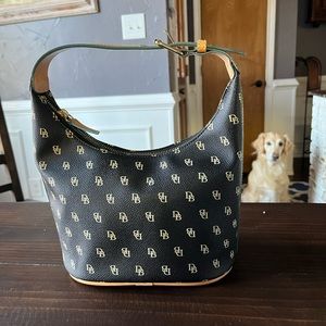 Dooney&Bourke small bucket purse .Black /light brown print ,blue inside .